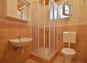 a bathroom with a toilet and a sink and a shower at Apartmani Danijela Lopar in Lopar +68 photos