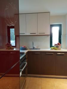 a kitchen with brown cabinets and a sink at Villa Avra in Poros +27 photos