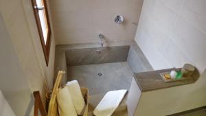 a small bathroom with a shower with a sink at Hotel Los Patios - Parque Natural in Rodalquilar