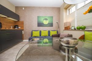 a living room with a couch and a glass table at Ambiente Apartments in Naumburg