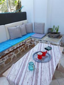 a coffee table with two red cups on a table at Filoxenia Apartments in Skala Sotiros