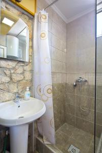 La salle de bains est pourvue d'un lavabo et d'une douche. dans l'établissement Apartman Kunjić, à Krimovice