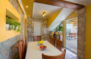 a dining room with a table with bananas on it at Apartman Kunjić in Krimovice