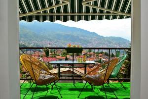 a table and chairs on a balcony with a view at Romantic in Sarajevo