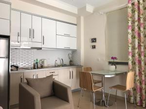 A kitchen or kitchenette at White Jasmine Apartment
