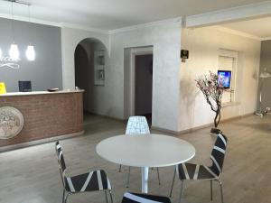 a room with a table and chairs and a counter at Hotel Bottaccio in Frascati