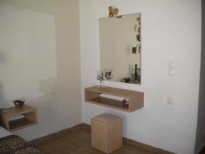 a bathroom with a sink and a mirror on the wall at Studios Katerina in Nydri +105 photos