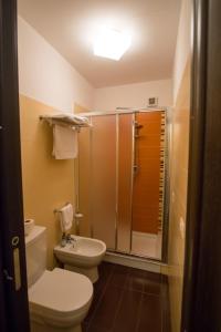 a bathroom with a toilet and a shower at Acitrezza B&B in Acitrezza