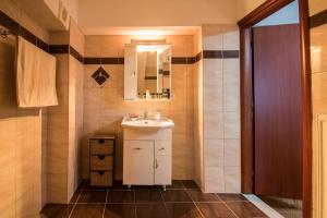 a bathroom with a sink and a mirror at Evaggelias Home Gavalochori in Gavalochori