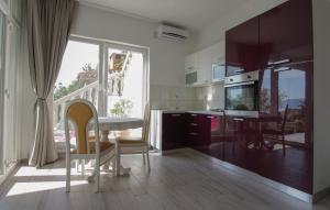a kitchen and dining room with a table and chairs at Apartments Tomas in Senj