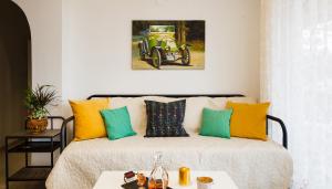 a bedroom with a bed with yellow and green pillows at Erofili's House in Kalo Chorio