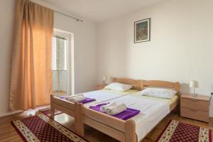 Postel nebo postele na pokoji v ubytování Apartments Novalja Milijan