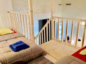 a room with two beds and a stair case at appartement Monaco Beausoleil in Beausoleil