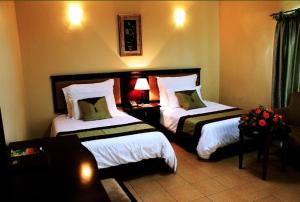 a hotel room with two beds in a room at Moba Hotel & Convention Centre in Kitwe