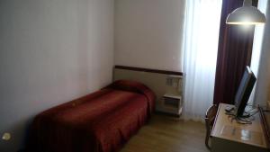 Postel nebo postele na pokoji v ubytování Hôtel Royal