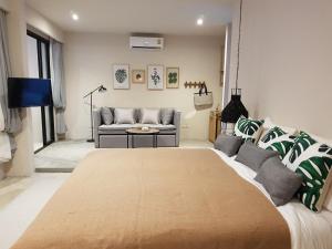 a living room with a couch and a table at Treevana Club Chiangmai in Chiang Mai