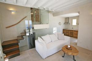 a living room with a white couch and a table at Atlantis Beach Residence in Super Paradise Beach