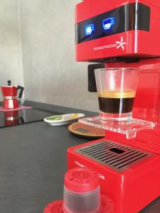 a red coffee maker with a cup of coffee at Matt5, il tuo angolino triestino in Trieste