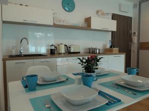 ポゴジェリツァにあるApartament 33BalticBlueのキッチン(食器、調理器具、テーブル付)