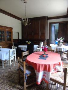 a dining room with a table with a red table cloth at Eco Logis de Chantegrolle in Champagne-Mouton