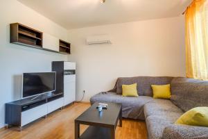 a living room with a couch and a flat screen tv at Bandalo in Mali Lošinj