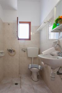 a bathroom with a toilet and a sink at Panorama Rooms in Agia Roumeli +45 photos
