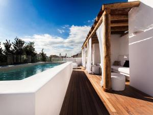 a white house with a swimming pool on a deck at HM Balanguera in Palma de Mallorca