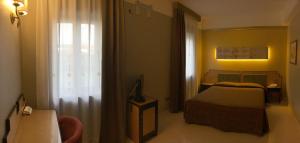 Postel nebo postele na pokoji v ubytování Hotel Orazio + 26 fotografií