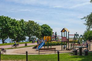 a park with a playground with a slide at Orłowska Riviera in Gdynia