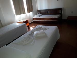 Säng eller sängar i ett rum på Plaza Hotel