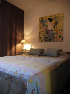 a bedroom with a bed and a painting on the wall at Albert 1er in La Rochelle