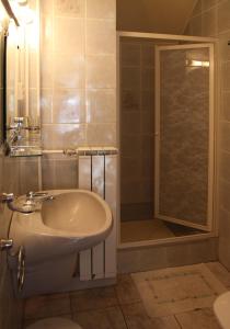 a bathroom with a sink and a shower at Éva Vendégház in Bük