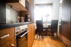 eine kleine Küche mit einem Tisch und Stühlen in der Unterkunft Apartment Aster in Wagrain
