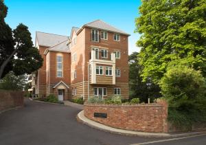 a large brick building with a driveway in front of it at Bounty Suite Basingstoke in Basingstoke