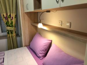 Ein Bett oder Betten in einem Zimmer der Unterkunft Apartments Galic