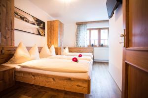 a bedroom with two beds with flowers on them at Grafenberg Chalet in Wagrain