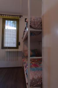 a room with three bunk beds and a window at Hostel Belgrade Shungit Dragana Jeftića br 10 in Belgrade