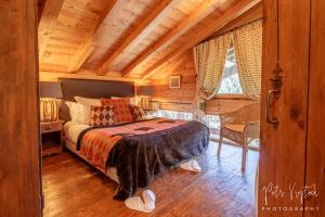 a bedroom with a bed and a wooden ceiling at Chalet Camomille in Les Gets