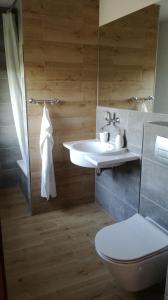 a bathroom with a sink and a toilet at Domek letniskowy w Rygoli in Rygol