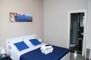 a bedroom with a bed with blue sheets and a basket at B&B Materdei 14 in Naples