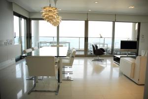 a dining room with a table and chairs and a chandelier at Super Luxury Penthouse in Jávea