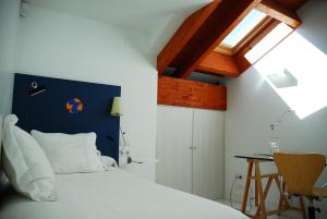 a bedroom with a white bed and a blue wall at Super Luxury Penthouse in Jávea +24 photos