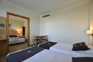 Postel nebo postele na pokoji v ubytování Tulip Inn Turin West Rivoli