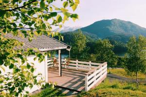 a wooden gazebo with a view of a mountain at Gjerdset Turistsenter in Isfjorden