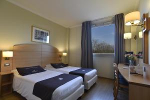 Postel nebo postele na pokoji v ubytování Tulip Inn Turin West Rivoli