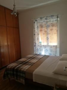 a bedroom with a bed and a window with a curtain at Costaguta Apartment in Rapallo