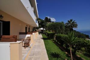 a balcony of a building with a view of the ocean at Veroniki Studios & Apartments in Moraitika