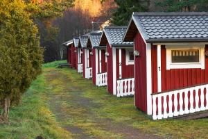 a row of red houses in a row at Maja Camping in Bottnaryd +6 photos