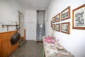 a hallway with a table and pictures on the wall at Al Molin B&B in Colico