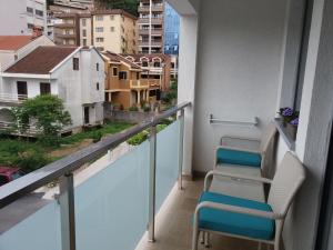 een balkon met stoelen en uitzicht op de stad bij Apolonia Lux Apartment in Budva